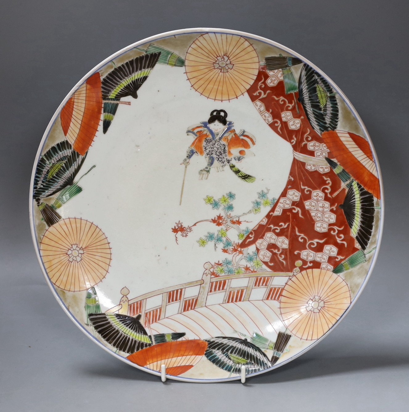 A Satsuma charger with decorative display and blue and white decoration to reverse, 31cm diameter